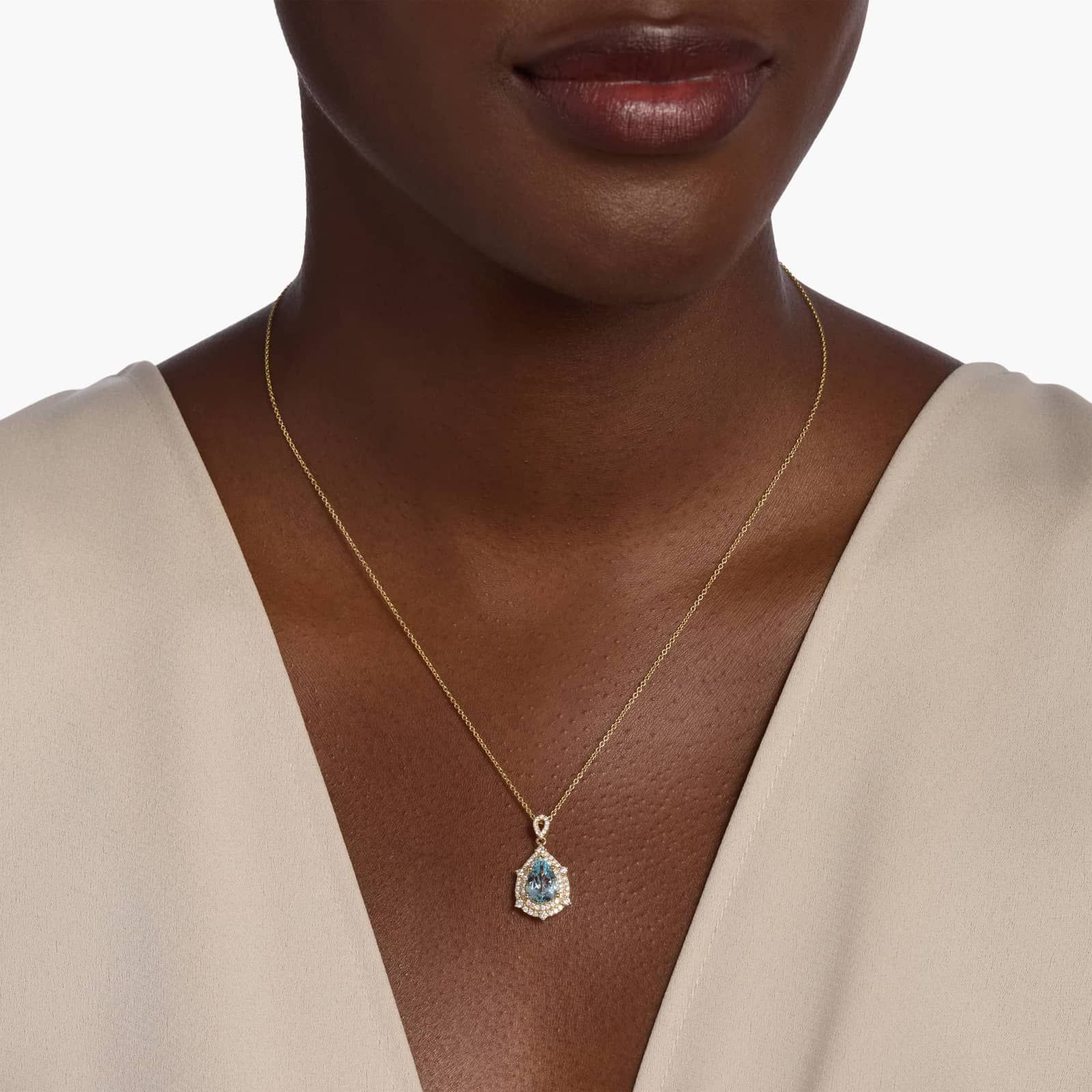 Pear Shaped Aquamarine and Diamond Double Halo Pendant in 14k Yellow Gold