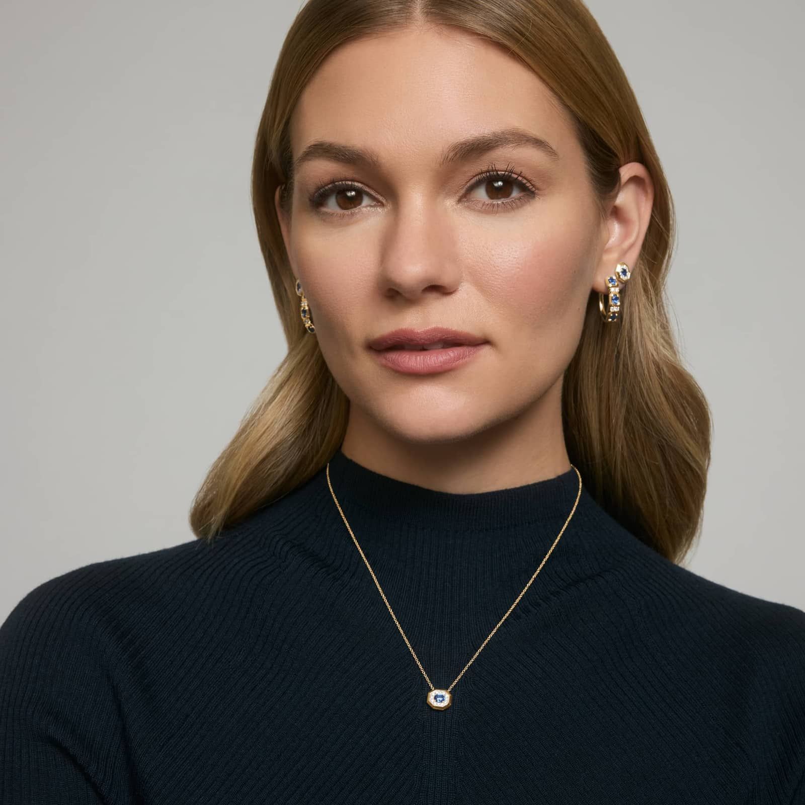 Oval Cut Blue Sapphire and Pavé Diamond Pendant Necklace In 14K Yellow Gold