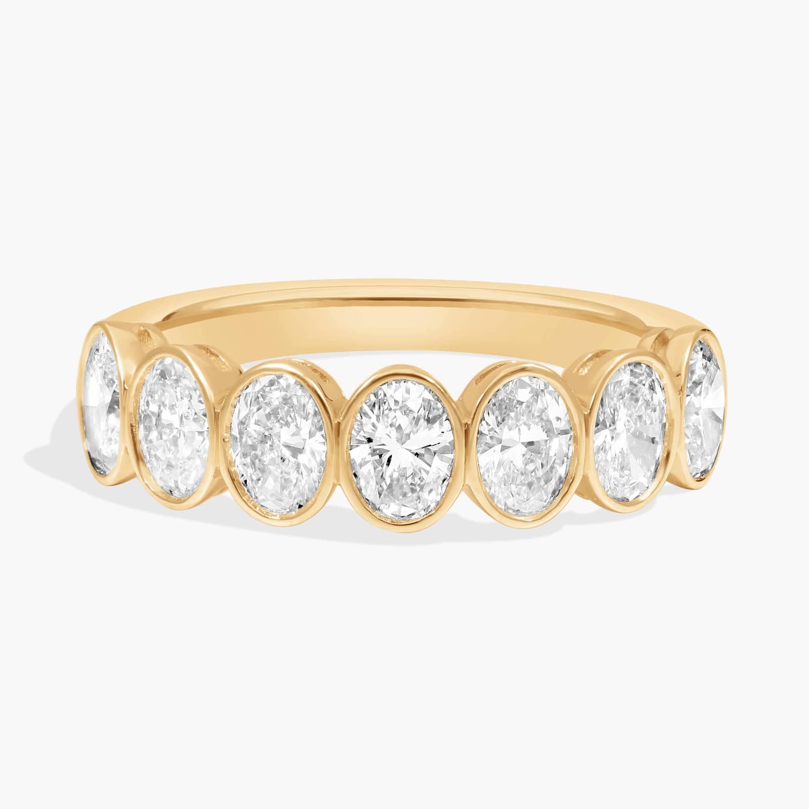 Seven Stone Bezel Anniversary Ring With 1.5 CTW Oval Cut Diamonds in 14K Yellow Gold (5mm)
