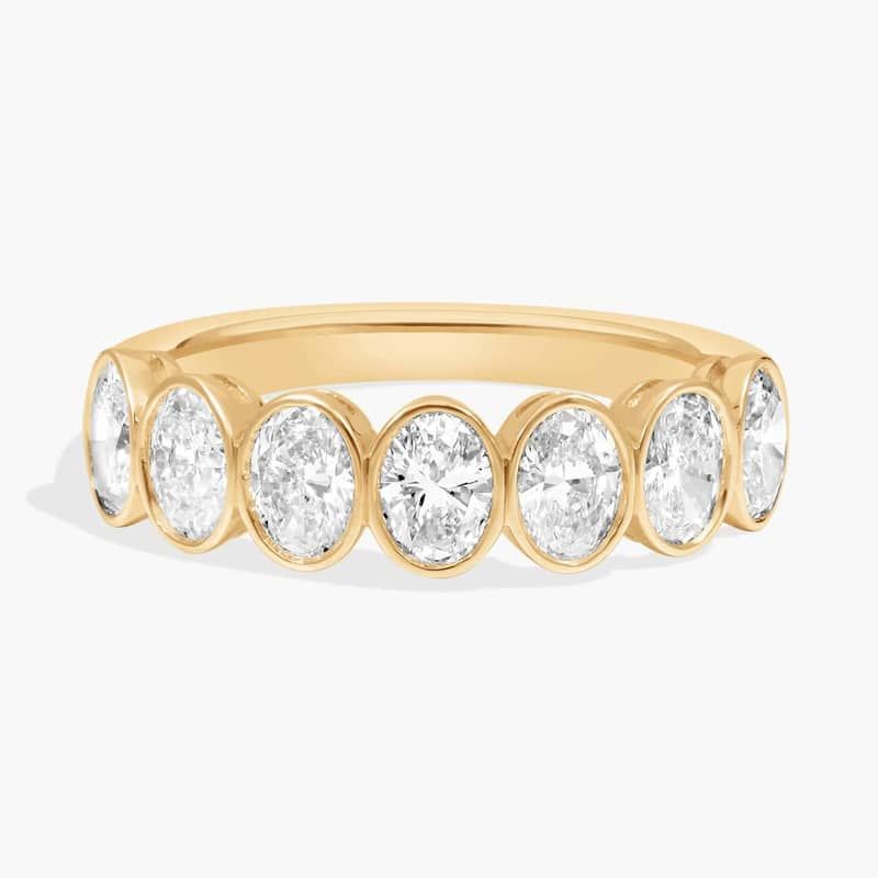 Seven Stone Bezel Anniversary Ring With 1.5 CTW Oval Cut Diamonds in 14K Yellow Gold (5mm)