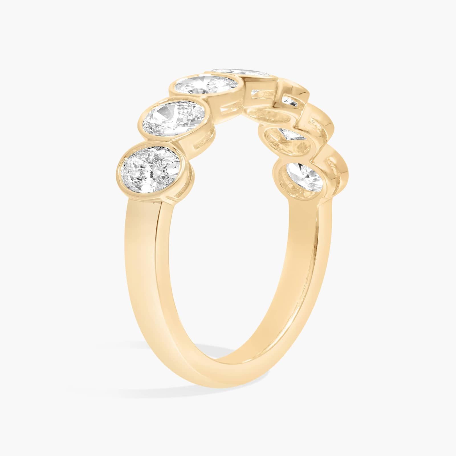 Seven Stone Bezel Anniversary Ring With 1.5 CTW Oval Cut Diamonds in 14K Yellow Gold (5mm)