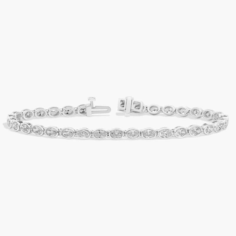 7 " Oval Cut Diamond E/W Bezel Set Tennis Bracelet In Platinum (5 Ct. tw. - H-I / SI1-SI2)