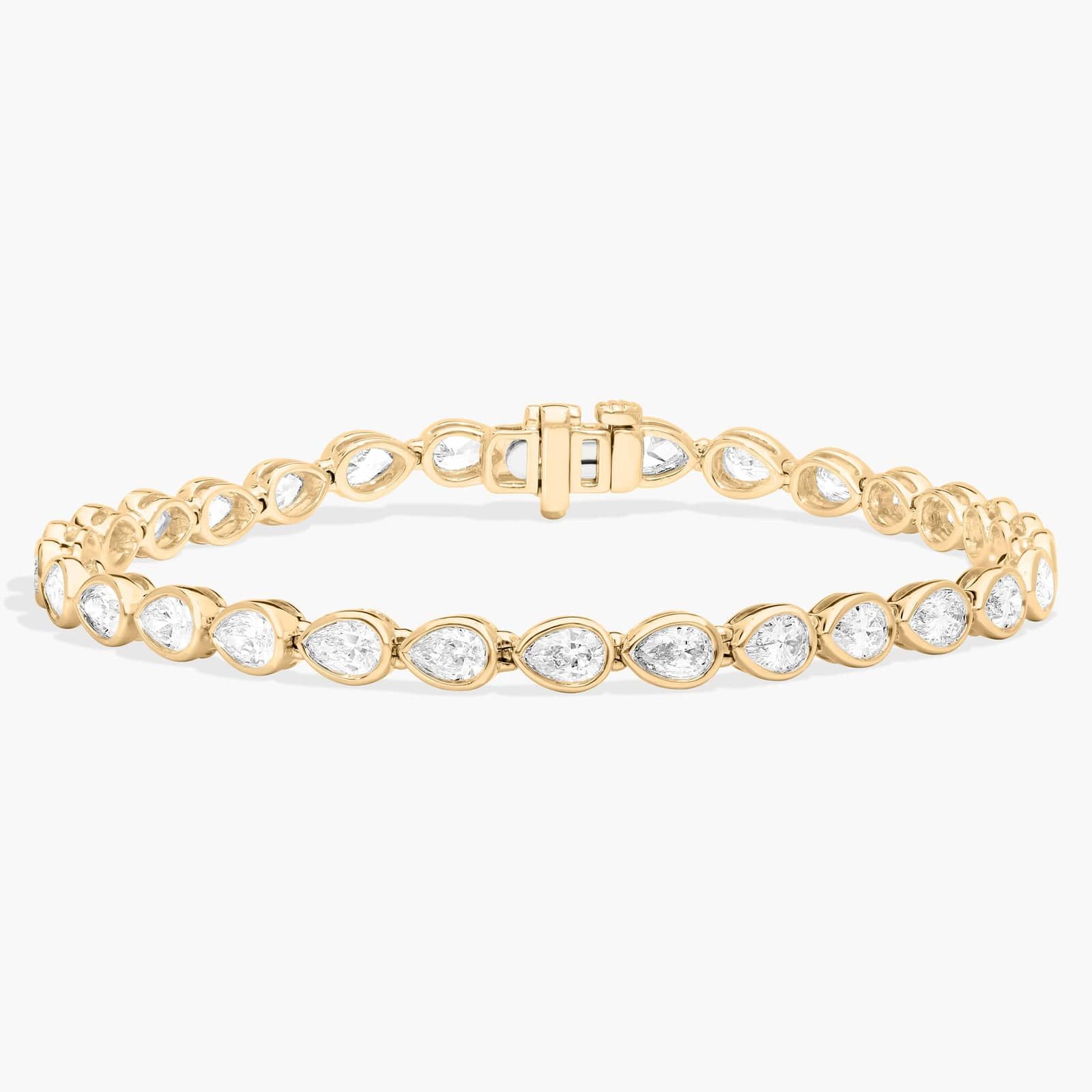 East-West Bezel Tennis Bracelet With 5 CTW Pear Shaped Diamonds in 14K Yellow Gold