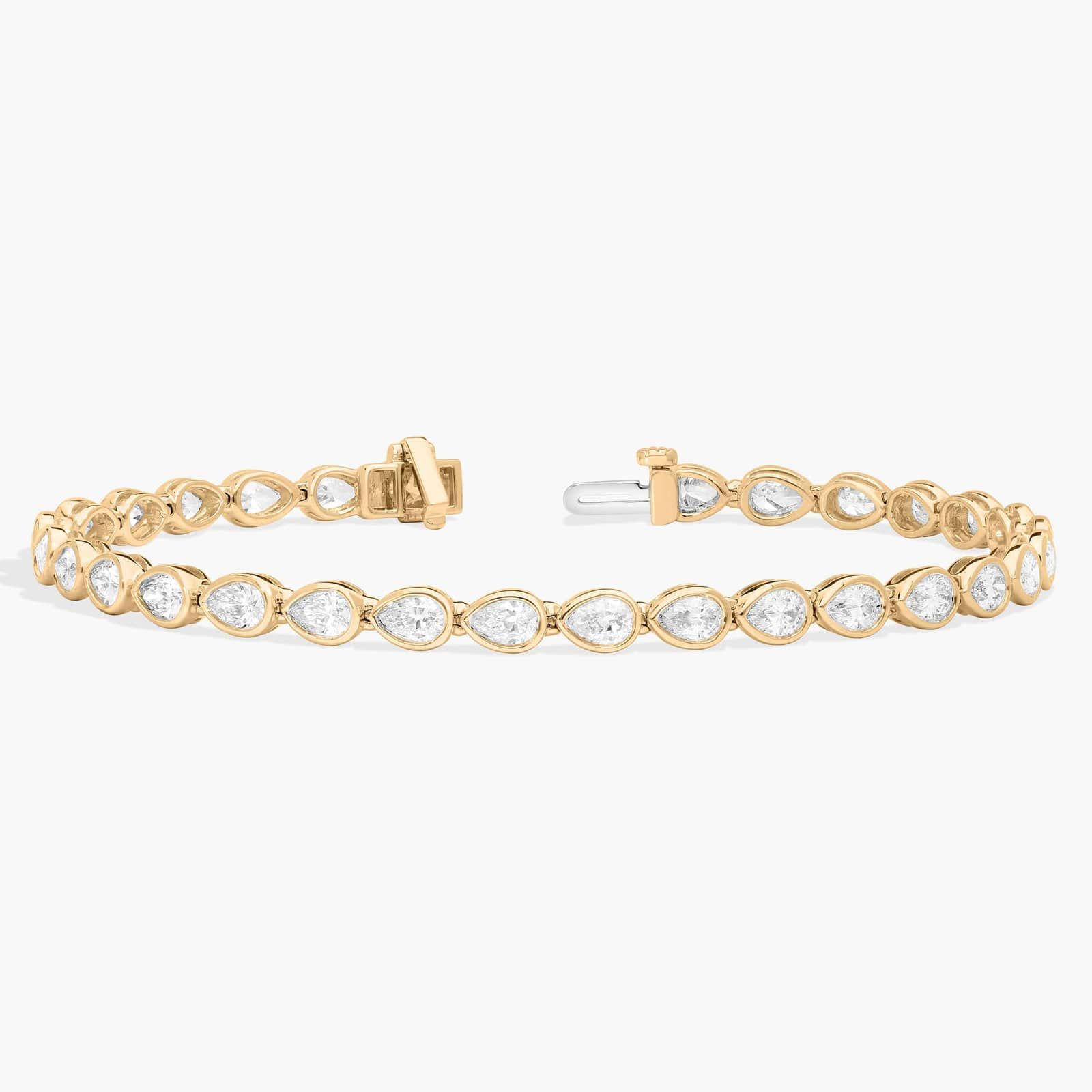 East-West Bezel Tennis Bracelet With 5 CTW Pear Shaped Diamonds in 14K Yellow Gold
