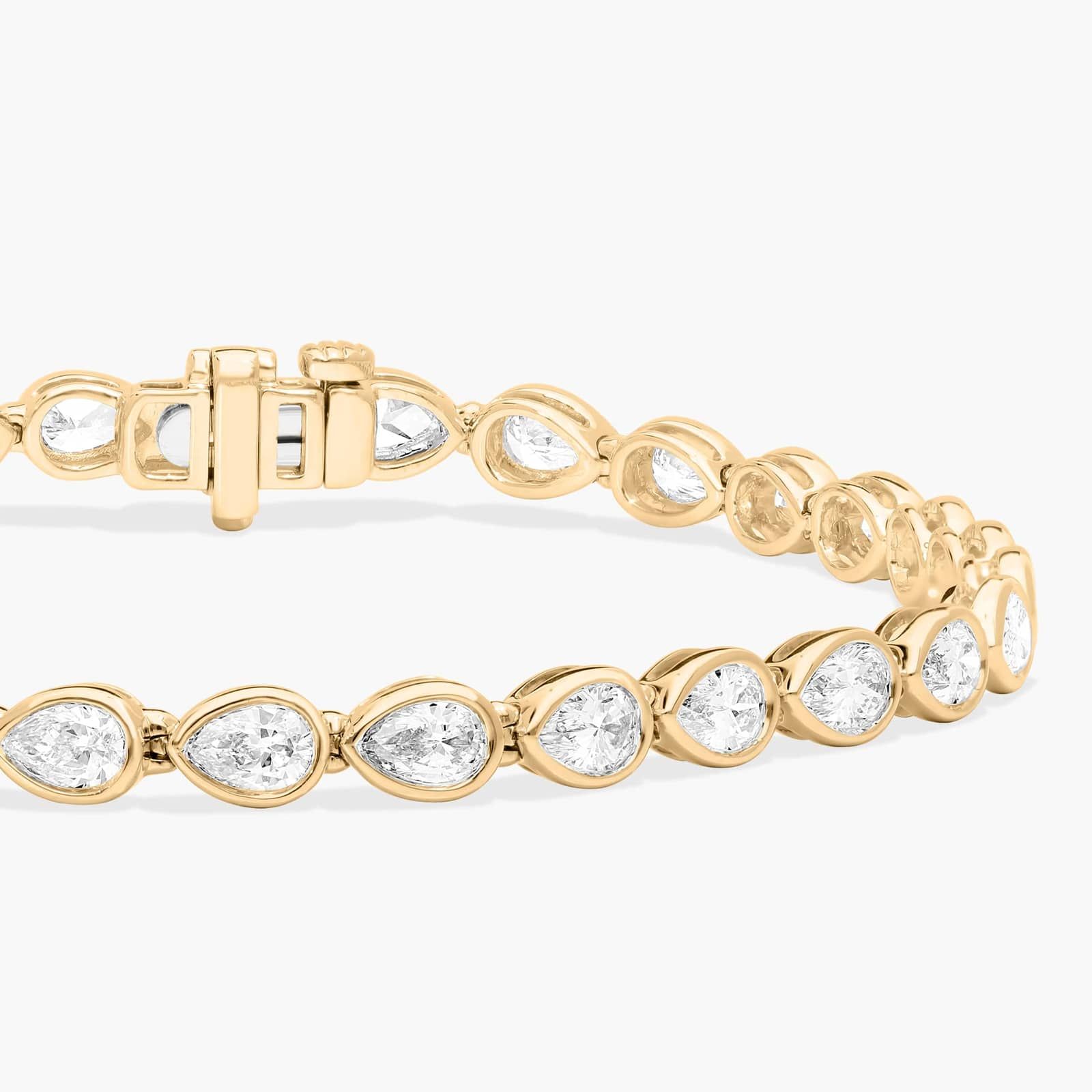East-West Bezel Tennis Bracelet With 5 CTW Pear Shaped Diamonds in 14K Yellow Gold