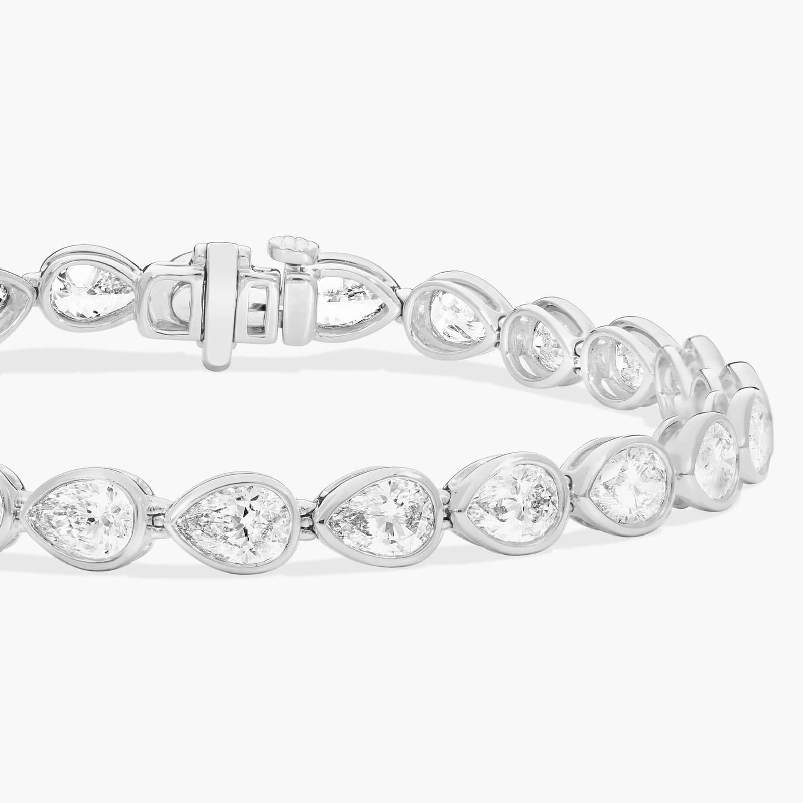 East-West Bezel Tennis Bracelet With 10 CTW Pear Shaped Diamonds in Platinum