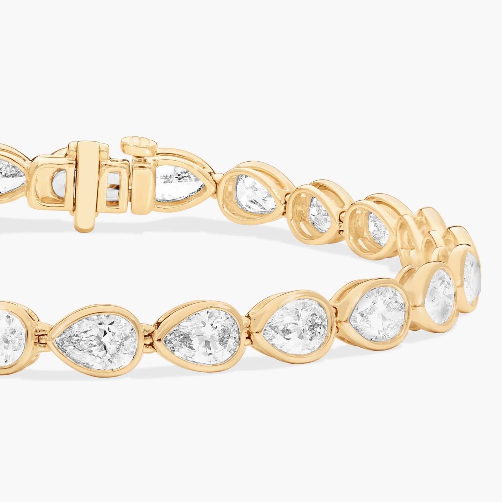 East-West Bezel Tennis Bracelet With 10 CTW Pear Shaped Diamonds in 14K Yellow Gold
