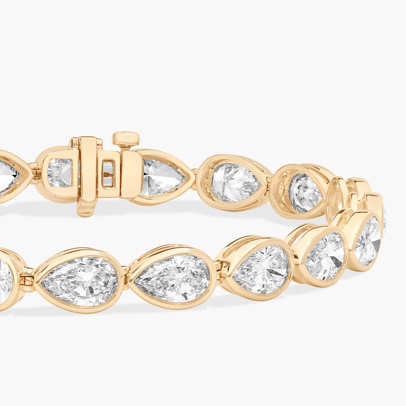East-West Bezel Tennis Bracelet With 15 CTW Pear Shaped Lab-Grown Diamonds in 14K Yellow Gold