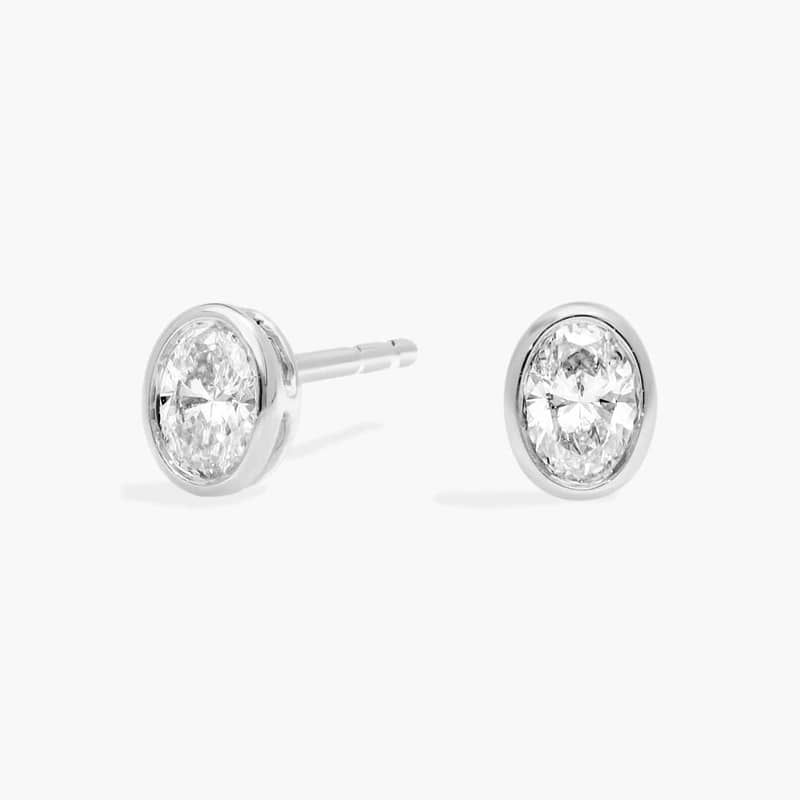 Bezel Diamond Stud Earrings With 0.25 CTW Oval Cut Diamonds in 14K White Gold