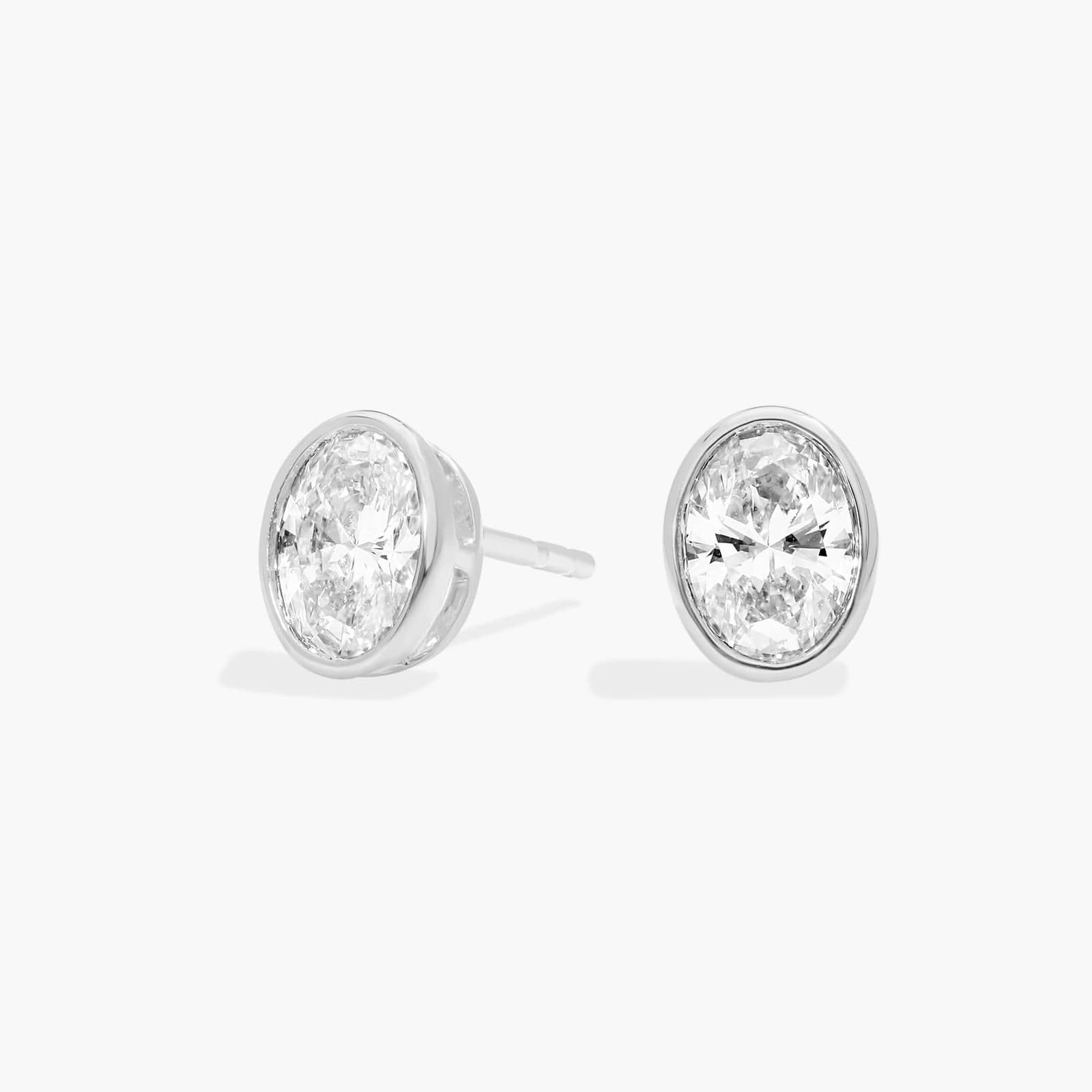 Bezel Stud Earrings With 0.75 CTW Oval Cut Lab-Grown Diamonds in 14K White Gold
