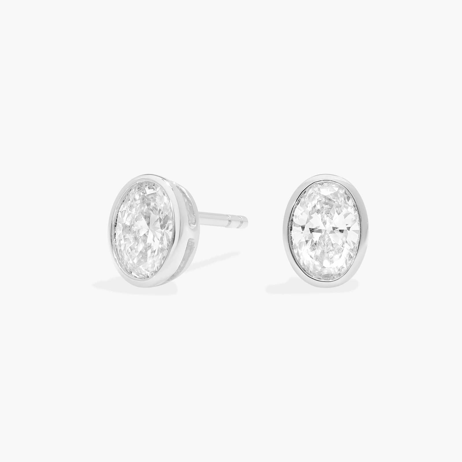 Bezel Diamond Stud Earrings With 1 CTW Oval Cut Diamonds in Platinum
