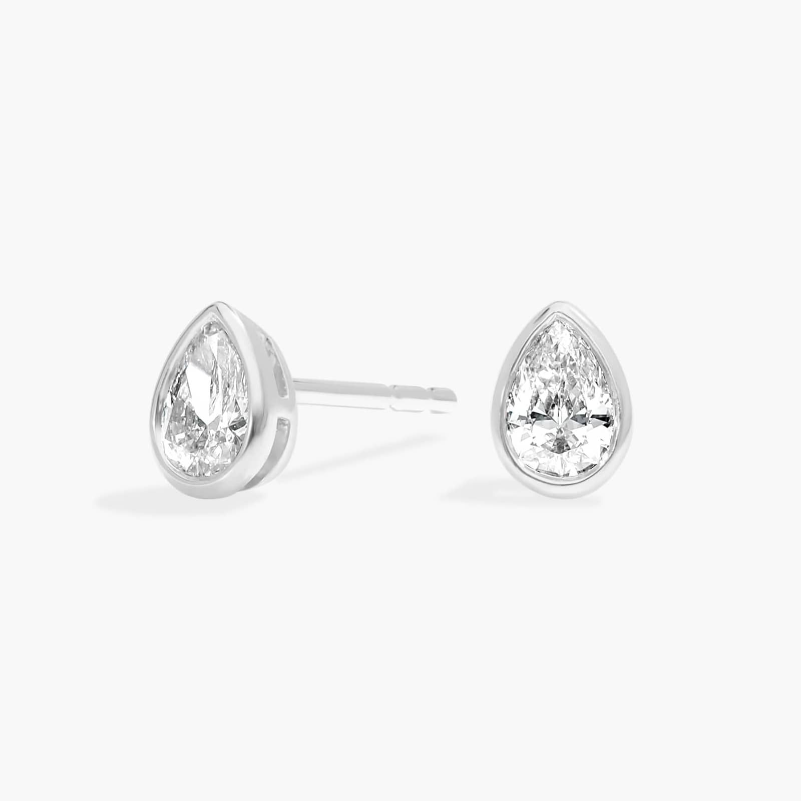 Bezel Diamond Stud Earrings With 0.25 CTW Pear Shaped Diamonds in Platinum