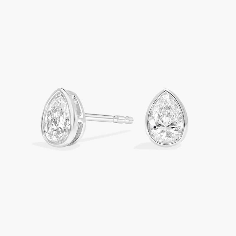 Bezel Diamond Stud Earrings With 0.5 CTW Pear Shaped Diamonds in Platinum