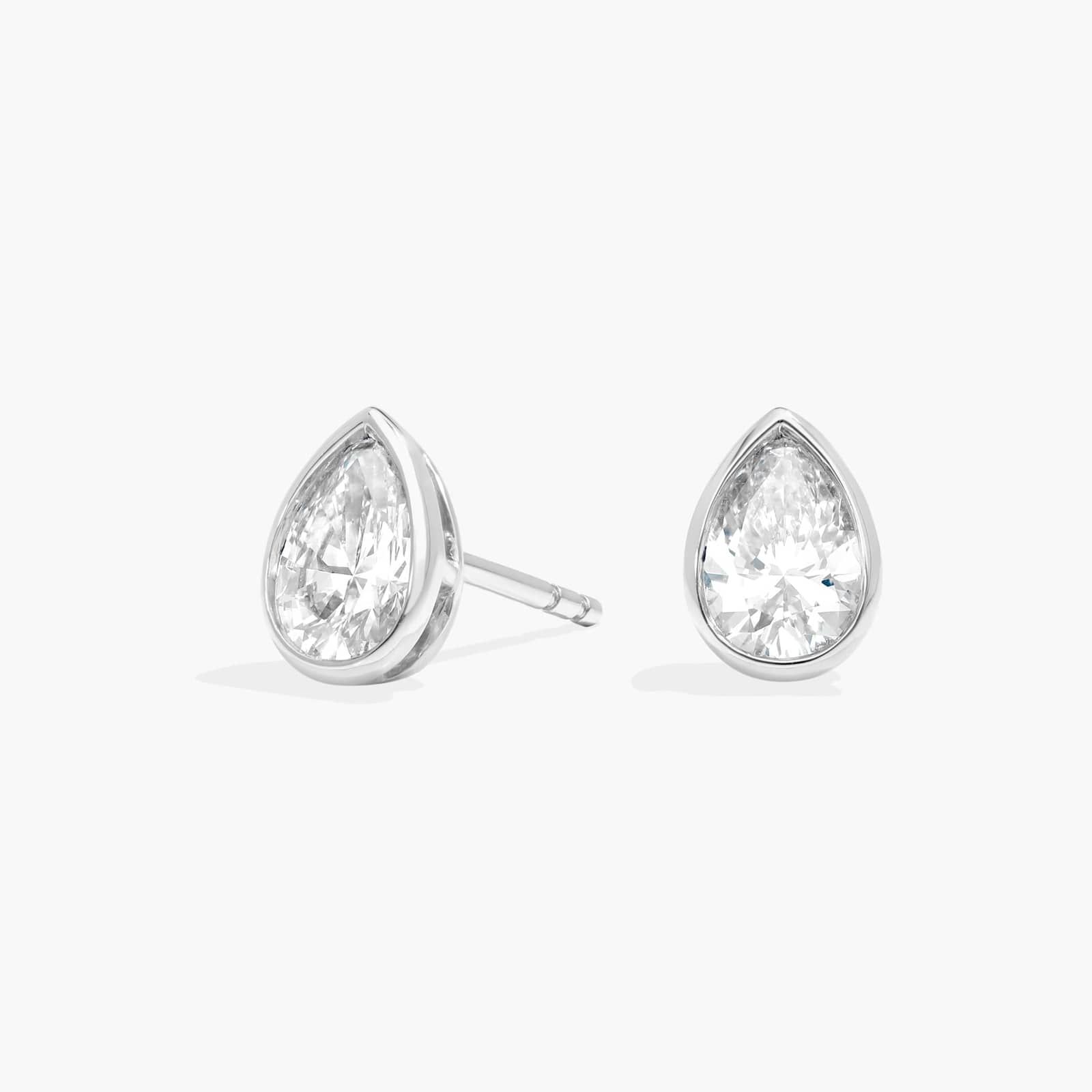 Bezel Diamond Stud Earrings With 1 CTW Pear Shaped Diamonds in Platinum