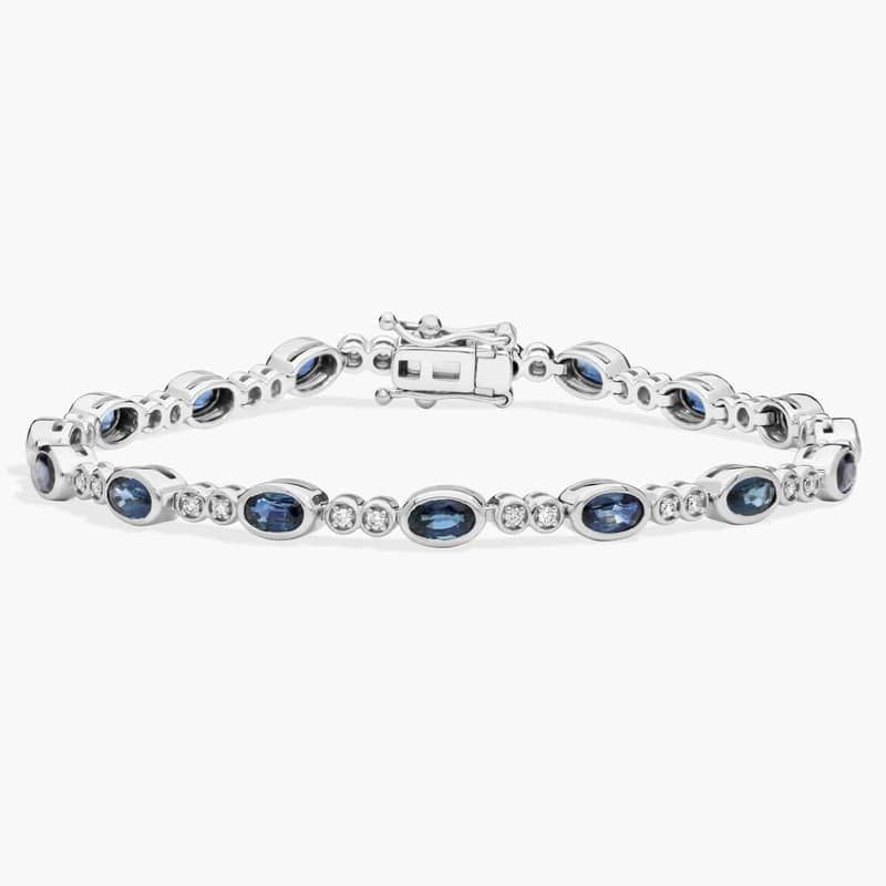 Alternating Oval Cut Blue Sapphire and Diamond Bracelet with 0.3 CTW Round Cut Diamonds in 14K White Gold Bezel Setting