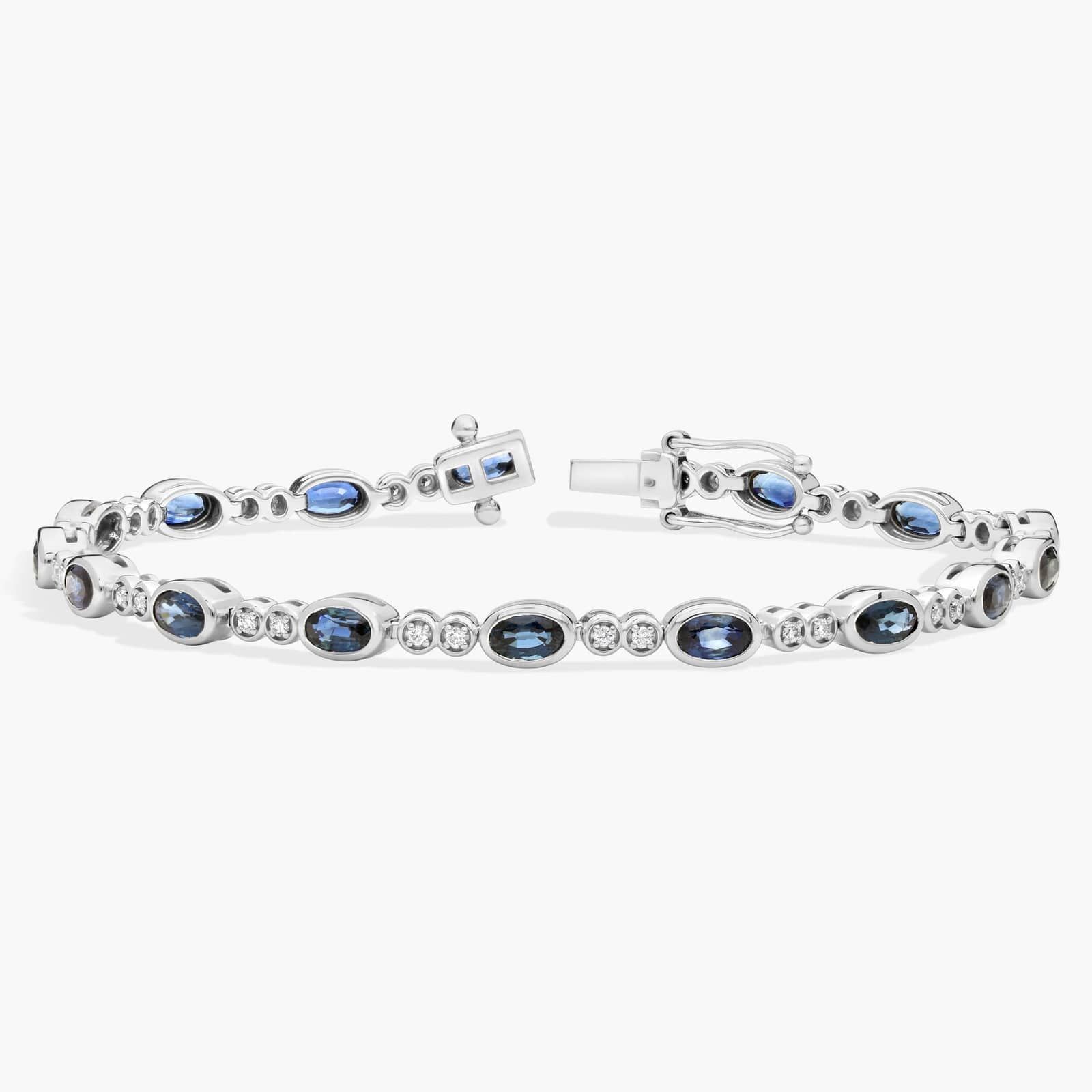 Alternating Oval Cut Blue Sapphire and Diamond Bracelet with 0.3 CTW Round Cut Diamonds in 14K White Gold Bezel Setting