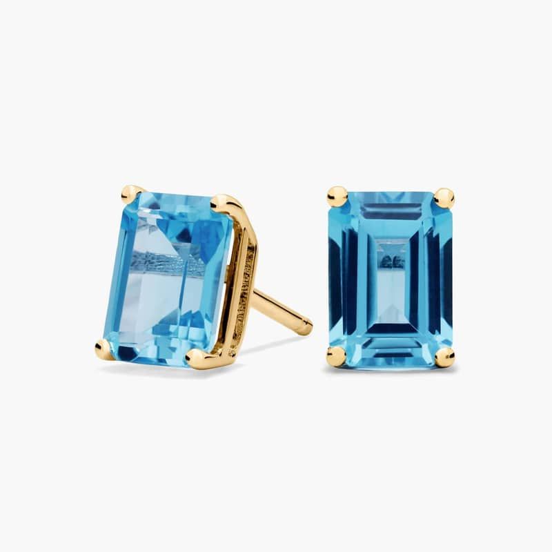 Emerald Cut Birthstone Blue Topaz Stud Earrings in 14K Yellow Gold (7x5mm)