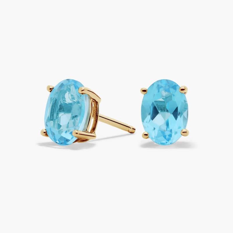 Oval Birthstone Blue Topaz Stud Earrings in 14K Yellow Gold (7x5mm)