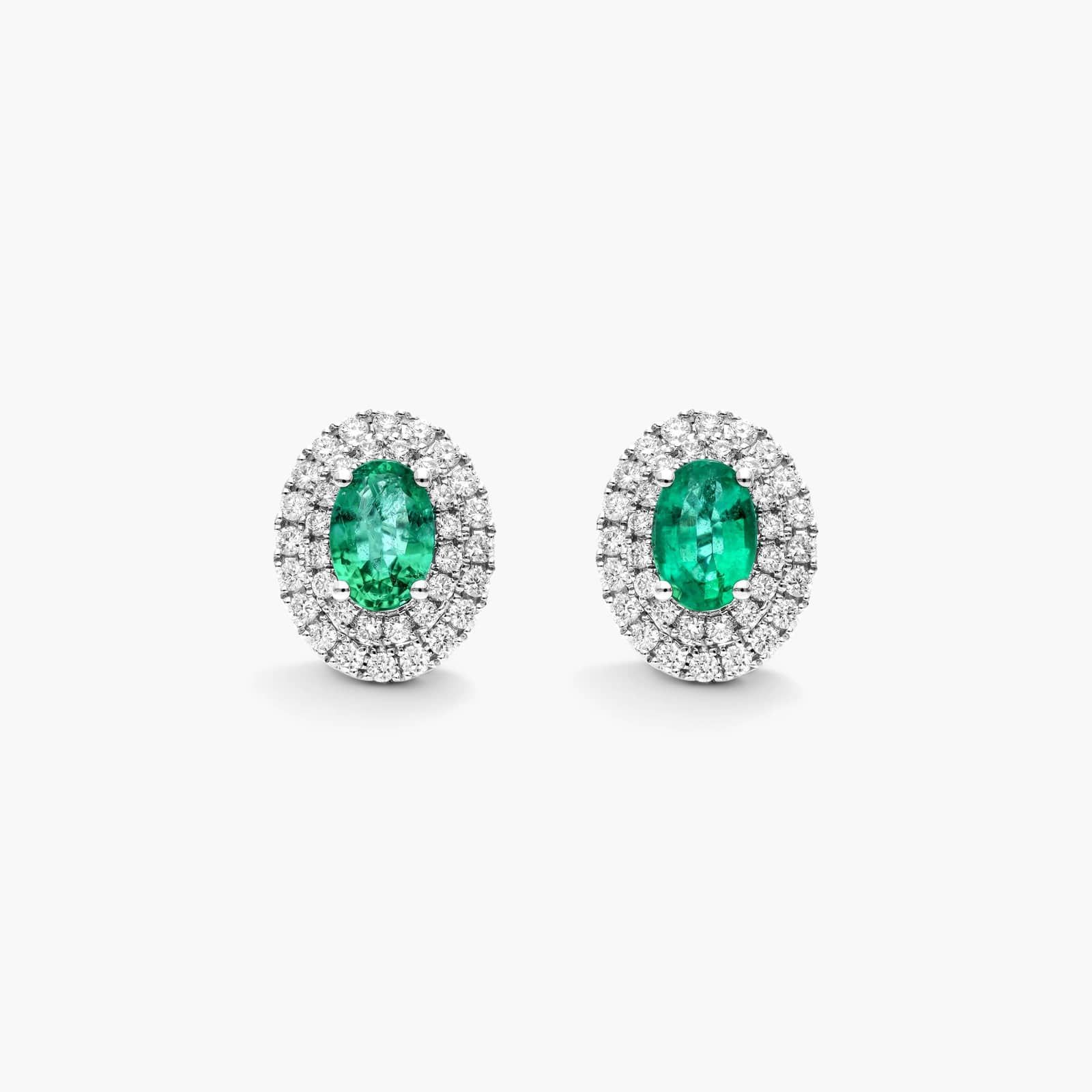 Oval Cut Emerald And Diamond Double Halo Earrings In 18K White Gold