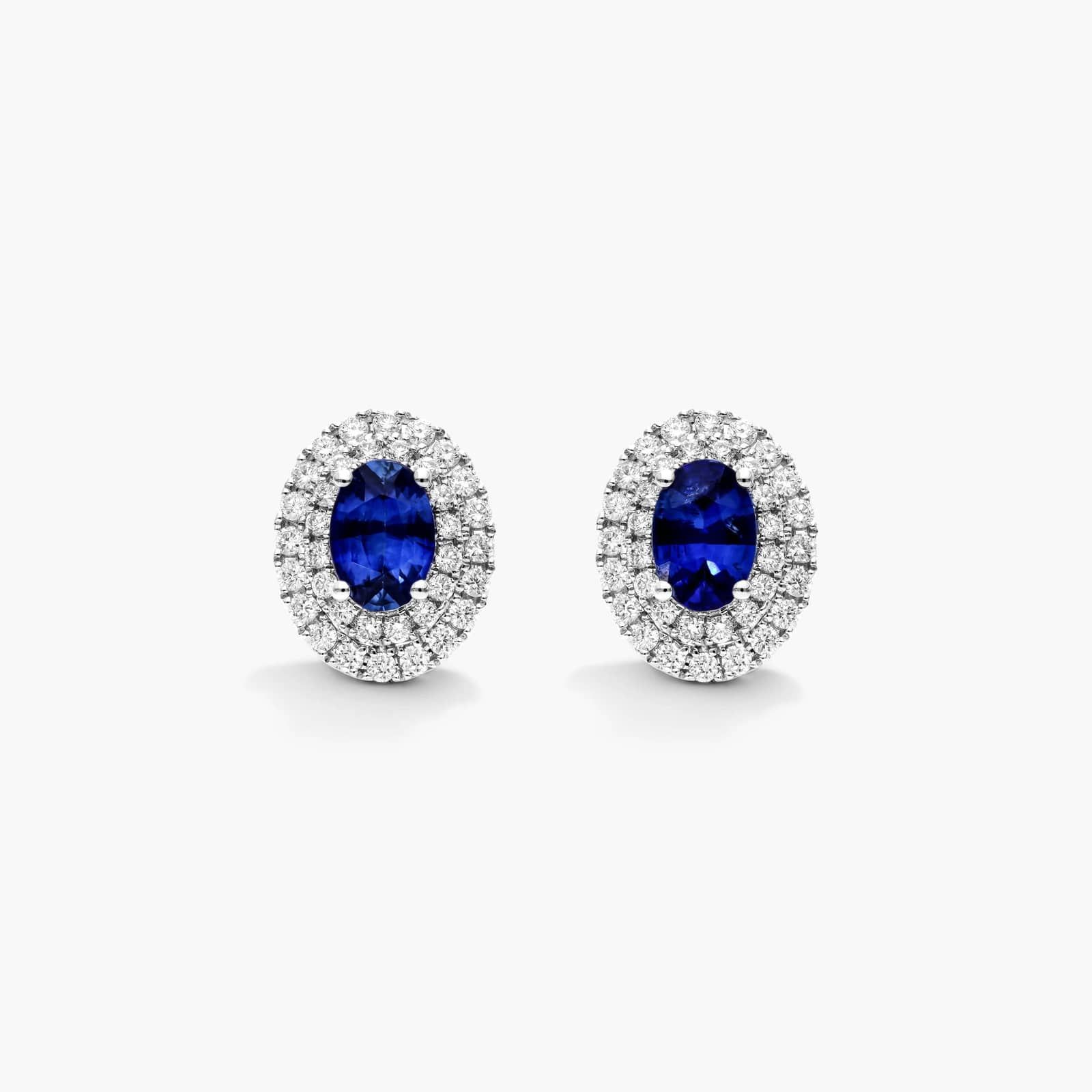 Oval Cut Sapphire And Diamond Double Halo Earrings In 18K White Gold
