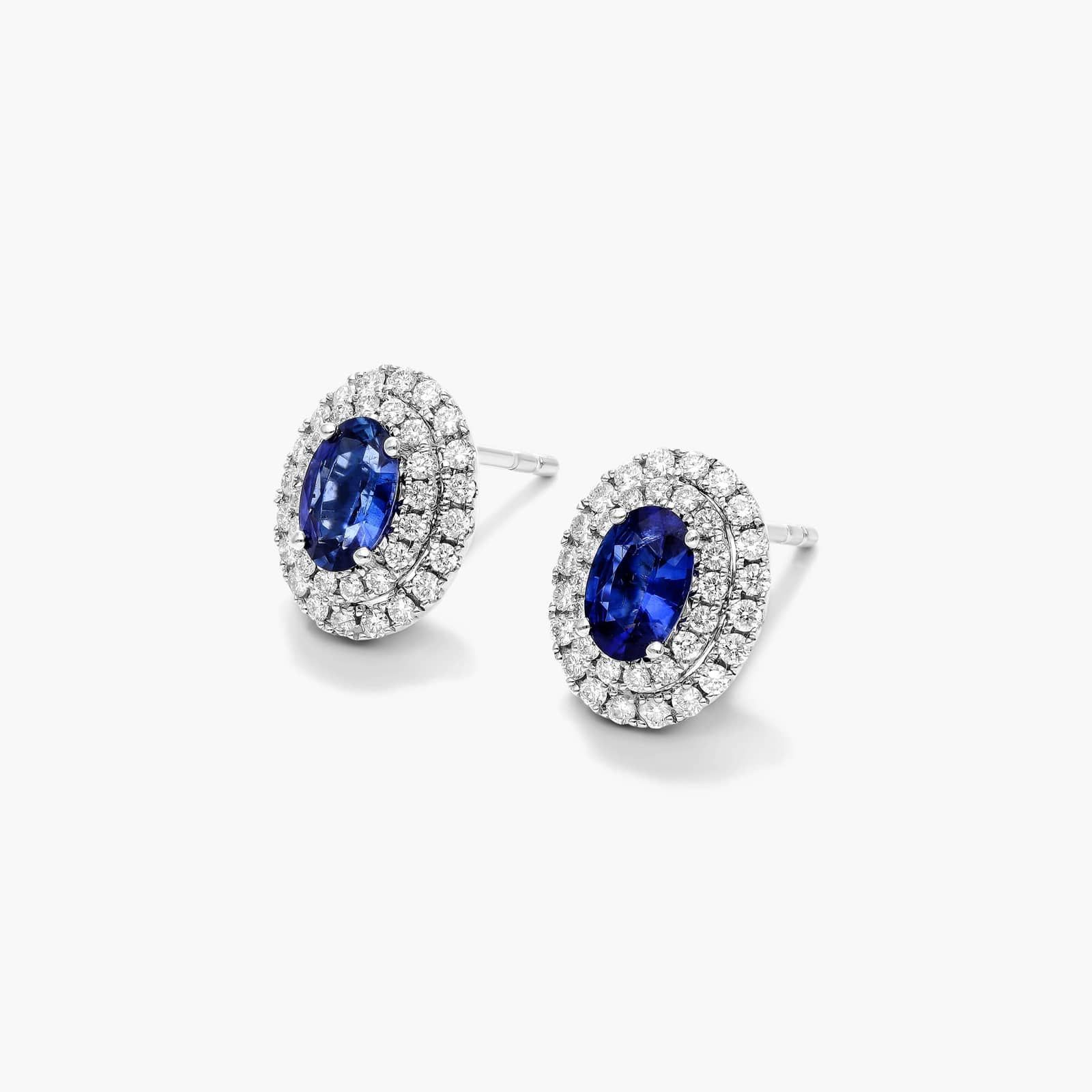 Oval Cut Sapphire And Diamond Double Halo Earrings In 18K White Gold