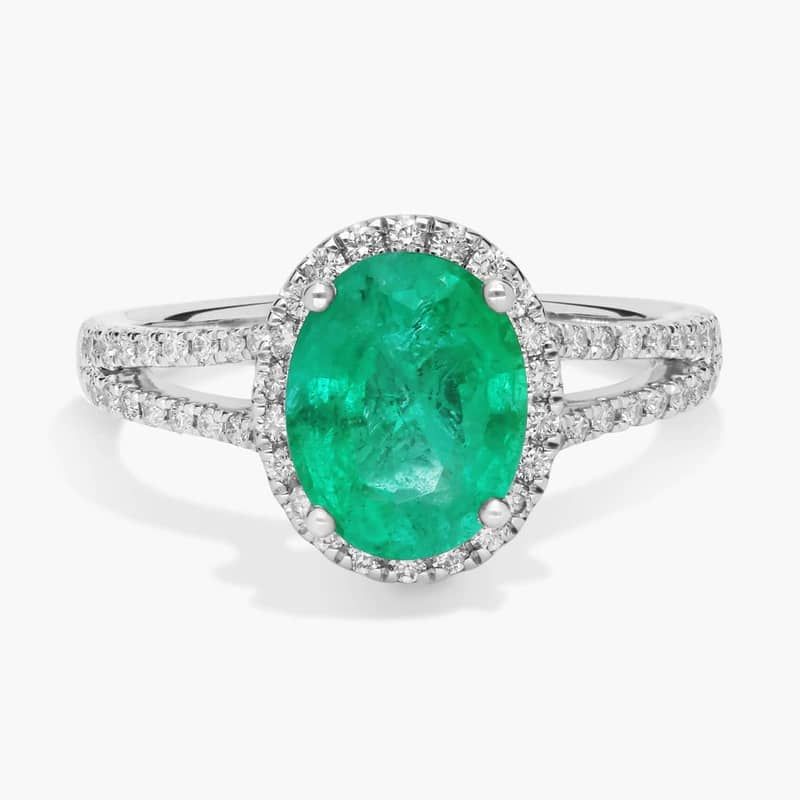 Oval Emerald and Diamond Halo Split Shank Ring in 14k White Gold (9x7mm)