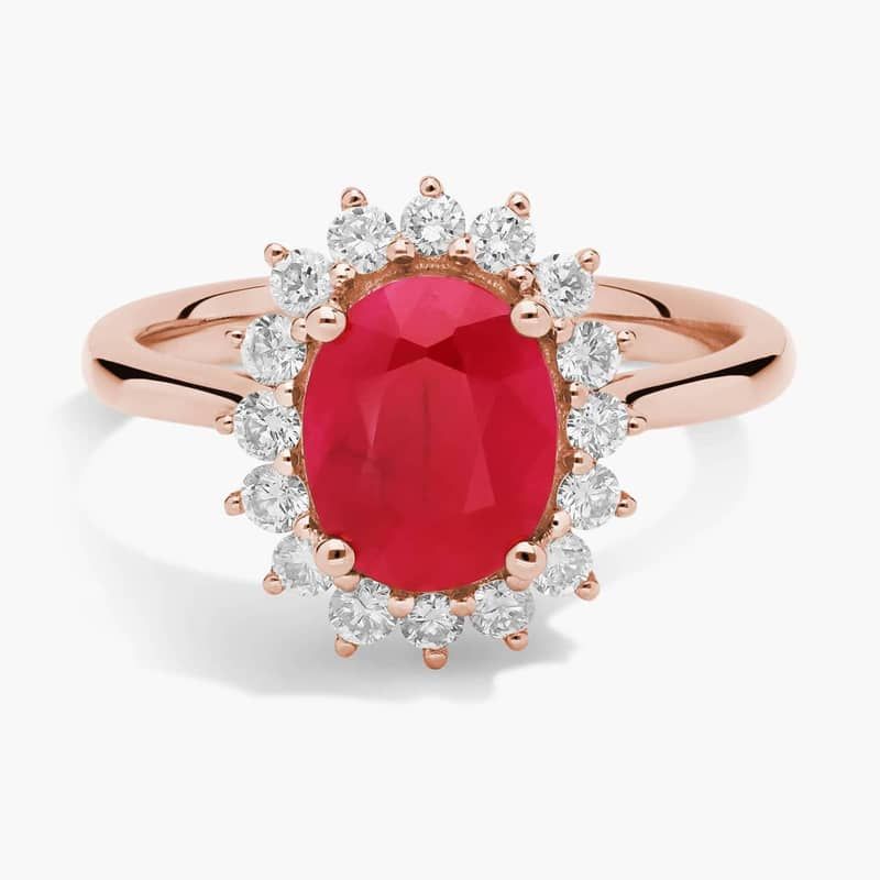 Oval Ruby and Diamond Sunburst Halo Ring in 14k Rose Gold (9x7mm)