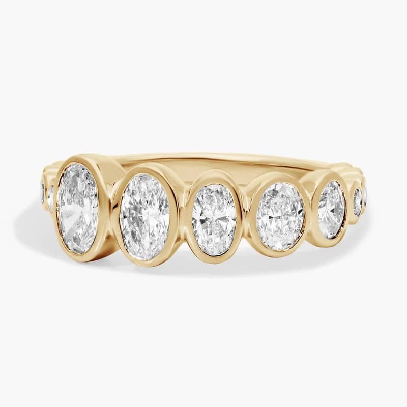 Oval Cut Graduated Lab-Grown Diamond Bezel Ring In 14K Yellow Gold