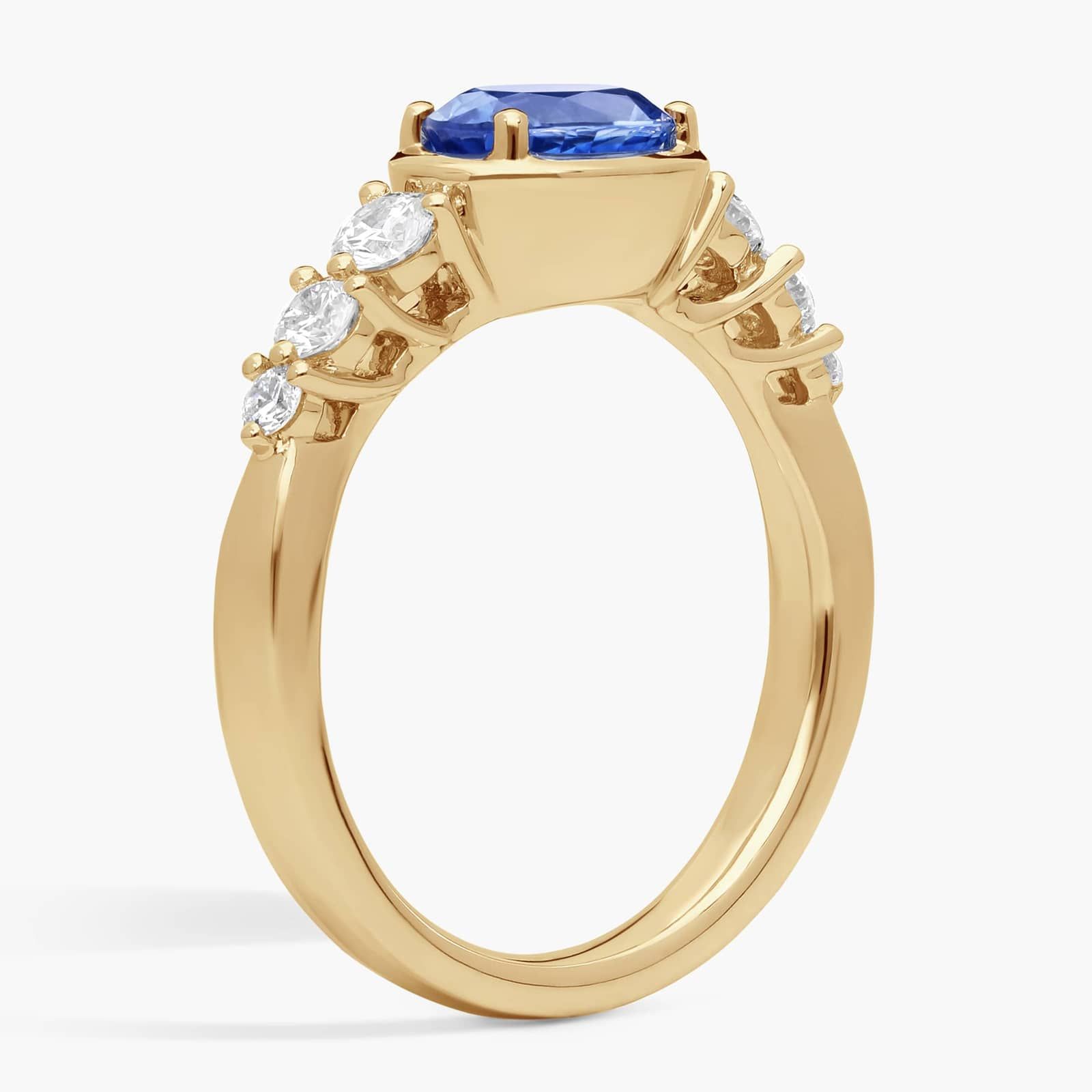 East-West Oval Cut Sapphire Ring With Half Bezel and Diamond Accent In 14K Yellow Gold