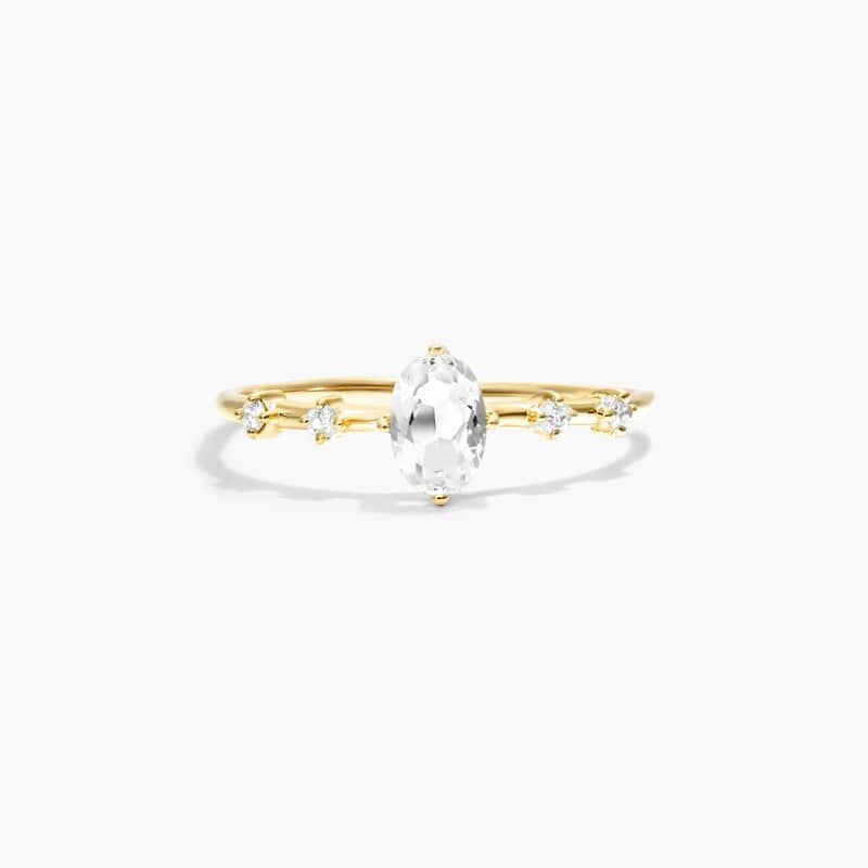 Oval White Topaz And Diamond Birthstone Ring In 14K Yellow Gold