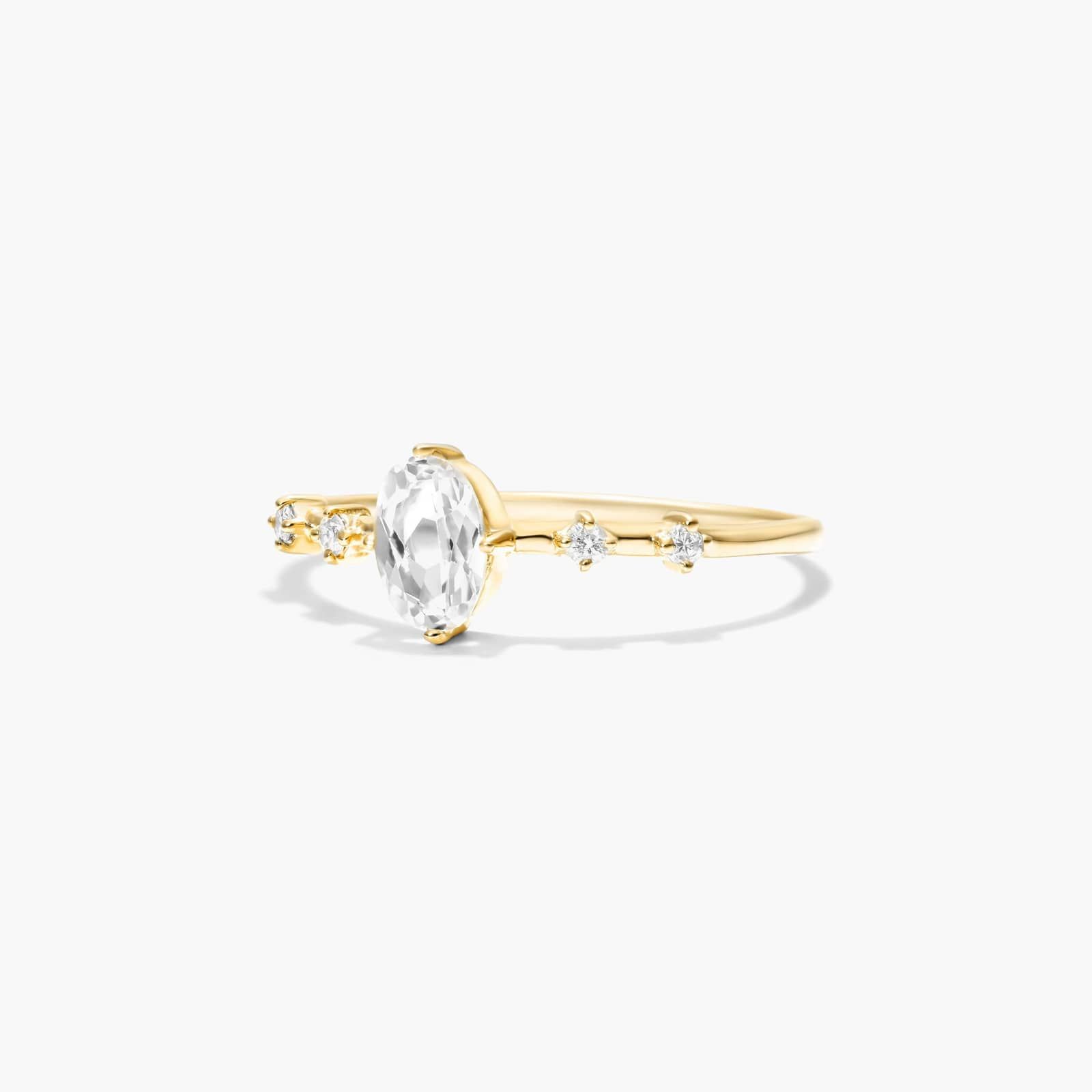 Oval White Topaz And Diamond Birthstone Ring In 14K Yellow Gold